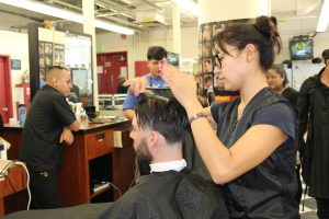 Ipolita Yecenia cutting a client's hair in a salon