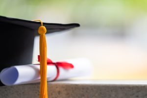 Partial image of a graduation cap and diploma