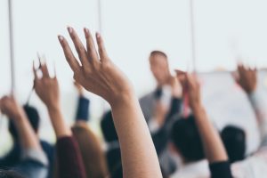 An audience raising hands