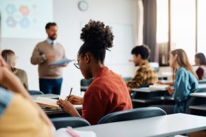 Classroom of adult students listening to their instructor