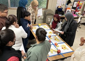 Adults and children learning English together in a family literacy class