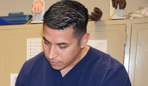 Manuel Martinez doing phlebotomy work in a lab