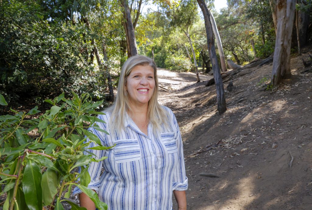 Portrait of Vista resident Daniela Grosso in a wooded area of Brengle Terrace Park.