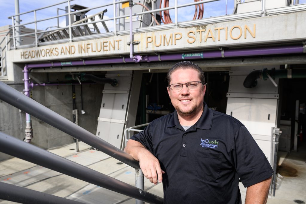 Anthony Canevaro leaning on a handrail at a water treatment plant