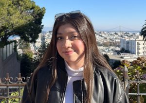 A photo of Johana Cruz standing outside in front of a city skyline