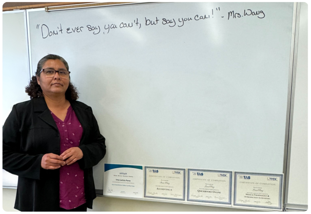 Irma Perez standing in front of a whiteboard looking towards the camera