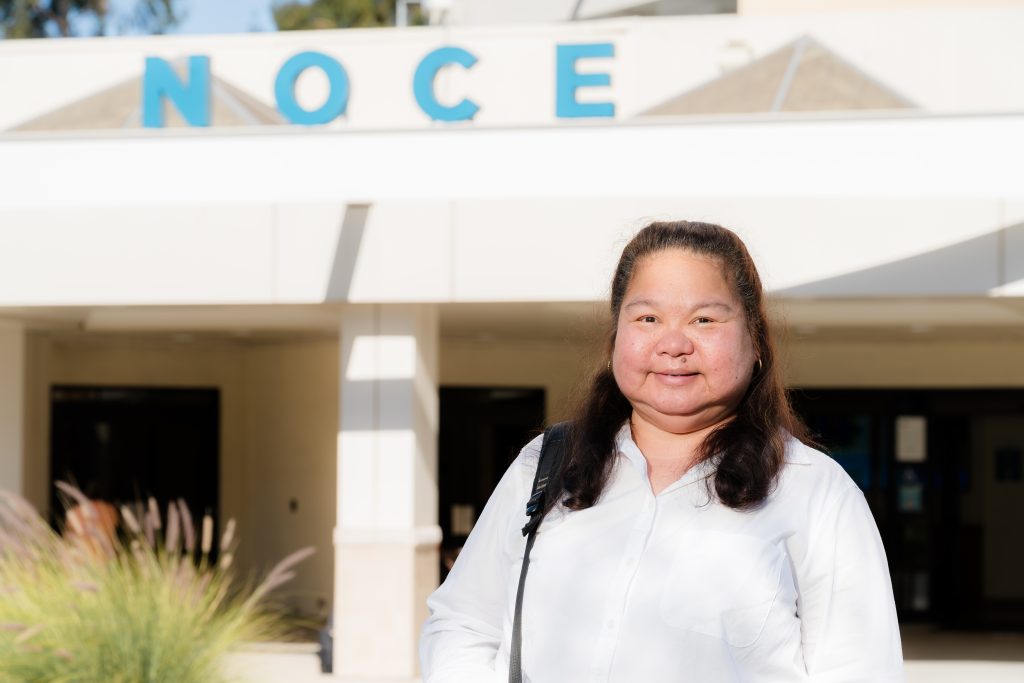 Eunice Worrel-Santos standing in front of the North Orange Continuing Education building