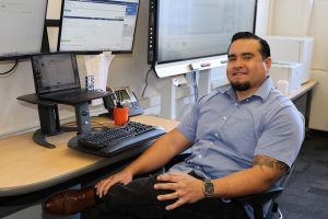 Oscar Magana sitting at a computer desk