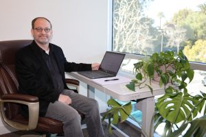 Jaime Fall sitting as a desk with a laptop computer