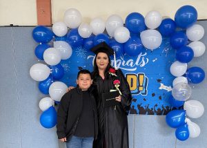 Perla Tapia in a cap and gown at her graduation with her son