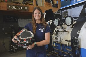 Emma Horanic standing with diving gear