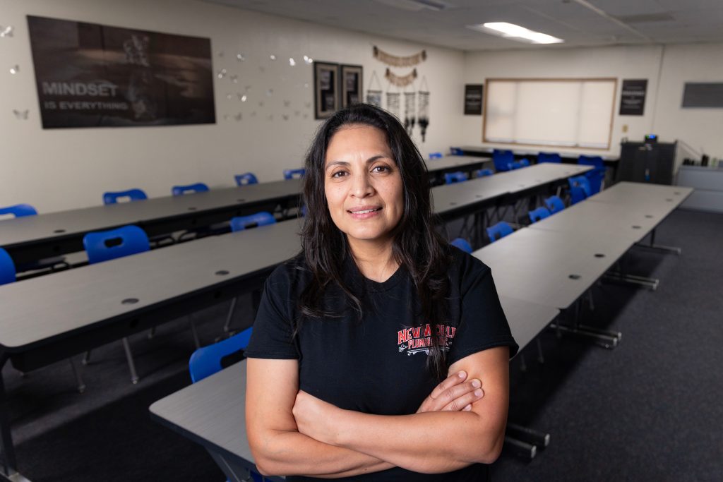 Lupita Ramirez Morales standing in an empty classroom