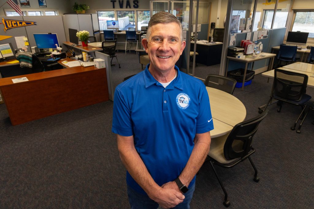 Teacher Chris Rivard standing in an empty office