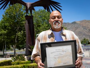 Gerardo Sanchez holding his diploma