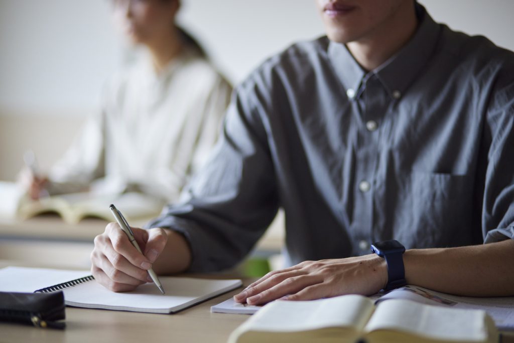 Adult students taking notes in a classroom