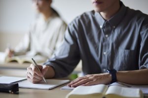 Adult students taking notes in a classroom