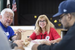 Karen Lingenfelter speaking with two men