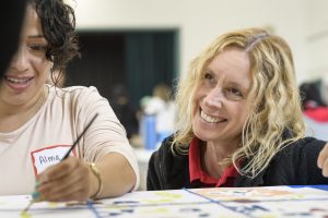Camille Stasuik smiles at a student
