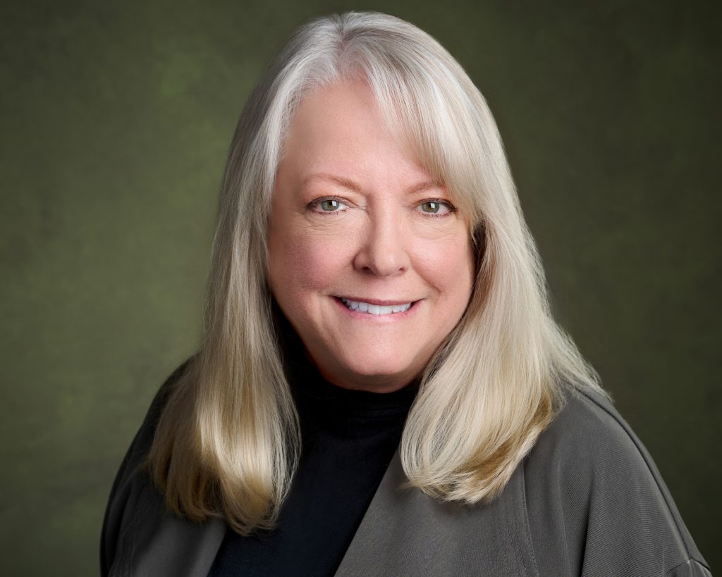 A portrait of Pam Garramone, smiling at the camera.