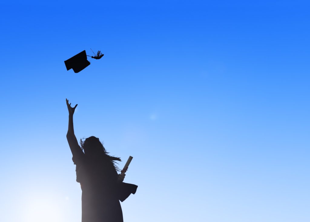 Silhouette Of Young Female Student Celebrating Graduation